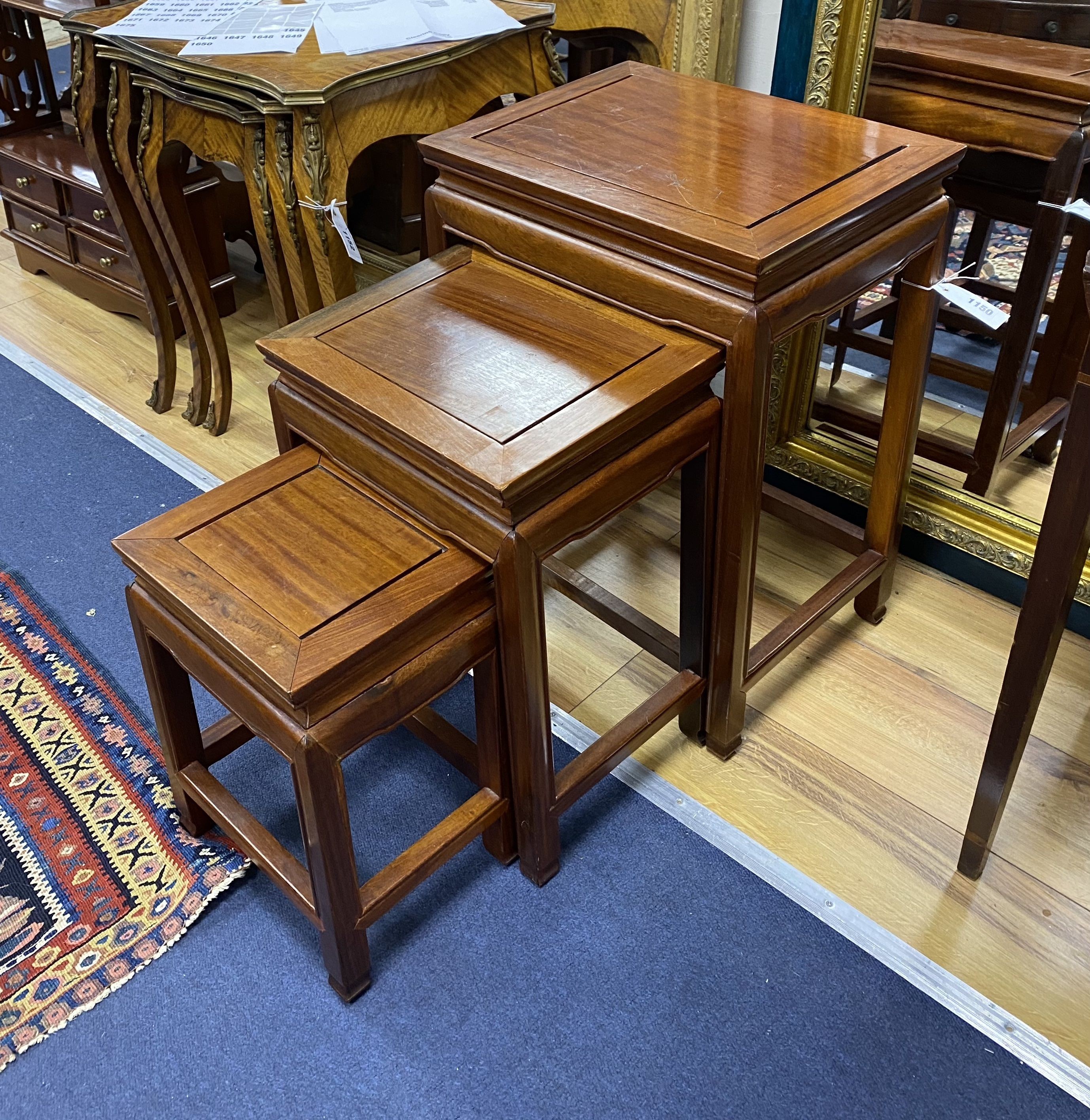 A nest of three rectangular Chinese occasional tables, width 40cm, depth 31cm, height 56cm